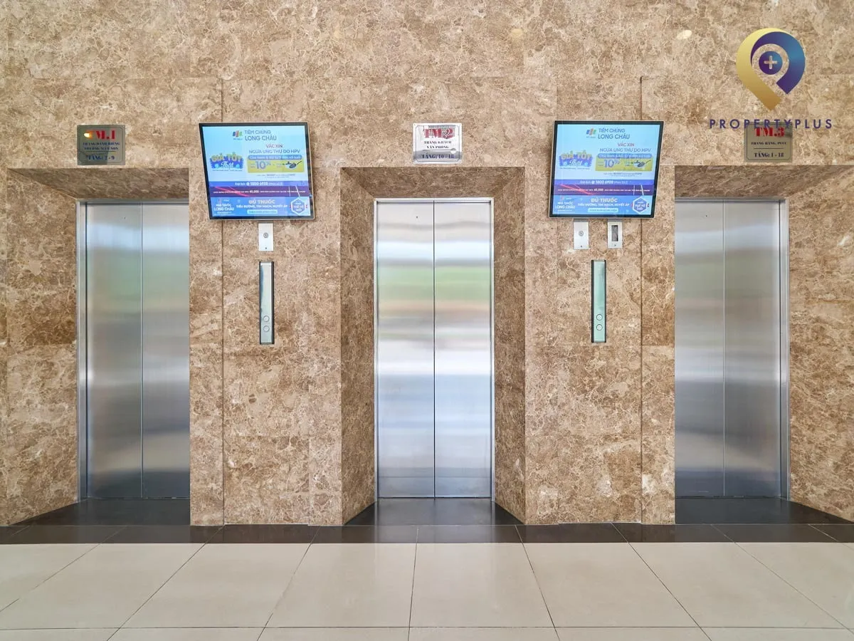 Elevators inside Sun Square building with modern design and digital screens